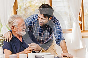 Young man love and care elder eating lunch meal for safe and stay at home happy smile family