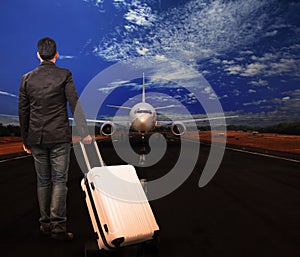 Young man and luggage on airport runways