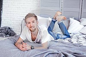 Young man lying in bed