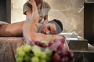 Young man lying down during traditional acupressure procedure