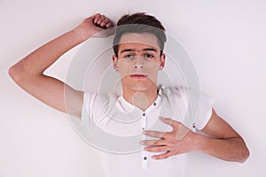 Young man, lying on the floor, thinking