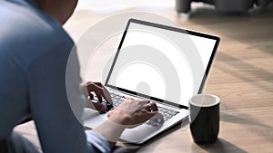 Young man lying on floor and using computer laptop.
