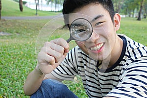 Young man with magnify glass