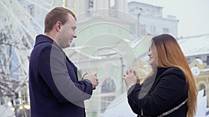 Young man makes marriage proposal to his girlfriend at ferris wheel background
