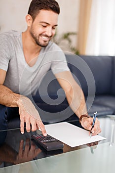 Young man making calculation