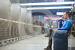 Young man making call at airport