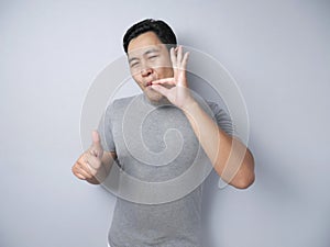 Young Man Making Delicious Hand Gesture