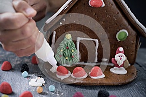 Young man making a gingerbread house