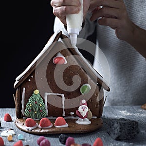 Young man making a gingerbread house