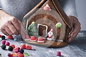 Young man making a gingerbread house