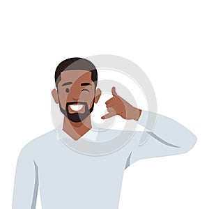 Young man making hand gesture asking to call back. Happy man demonstrate callback sign photo