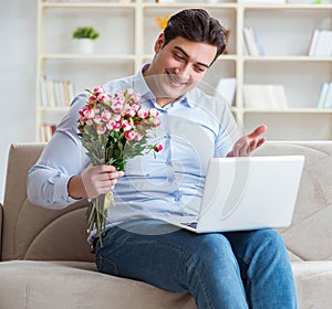 Young man making marriage proposal over internet laptop