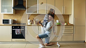 Young man making proposal to his girlfriend in the kitchen at home