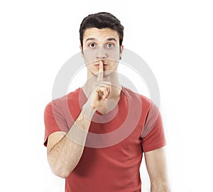 Young man making silence gesture