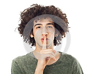 Young man making silence gesture