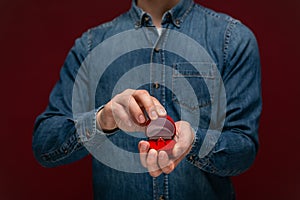 Young man making wedding proposal holding box with engagement ring.