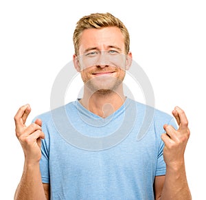 Young man making a wish isolated on white background