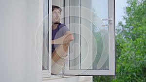 A young man in mandatory quarantine. He stays in one room for two weeks. He did not shave for a long time, he is