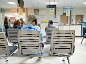 Young man and many people waiting medical and health services to the hospital