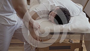 Young man at the masseur`s reception