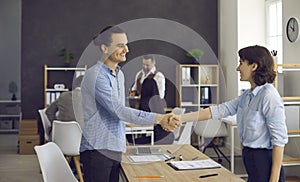 Young man and mature woman handshake in office after job recruitment meeting