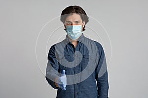 Young Man In Medical Mask And Gloves Extending Hand For Handshake