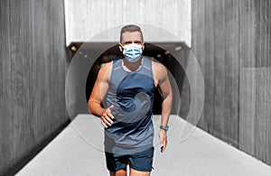 young man in medical mask running outdoors