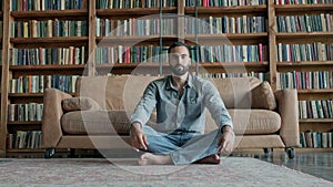 Young Man Meditates In The Library.