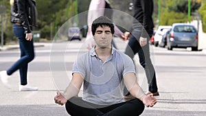 Young man meditating in the middle of the street, for mindfulness concepts