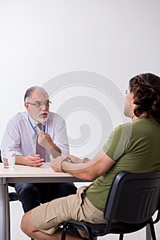 Young man meeting with advocate in pre-trial detention