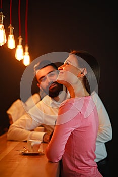 Young man met behind the bar with girl in nightclub