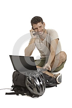 Young man on mobile having helmet smiling