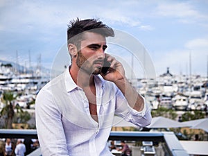 Young man in Monaco talking on mobile phone