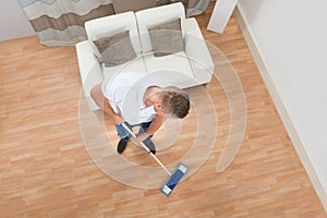 Young Man Mopping Floor