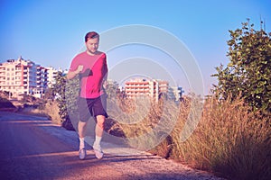 Young man on a morning jog in the countryside toned