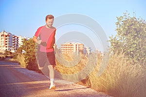 Young man on a morning jog in the countryside toned