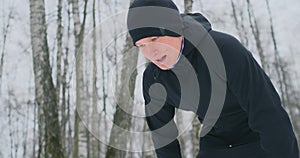 A young man on a morning jog in the winter forest was tired and stopped to rest and ran on. He recovered his strength