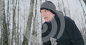 A young man on a morning jog in the winter forest was tired and stopped to rest and ran on. He recovered his strength