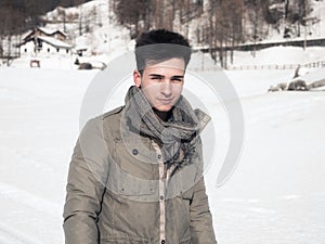 Young man in the mountain in winter with snow