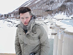 Young man in the mountain in winter with snow