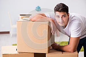 The young man moving boxes at home