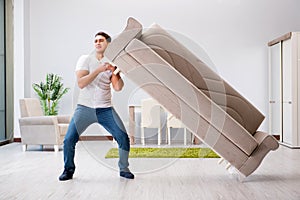 The young man moving furniture at home