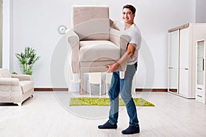 The young man moving furniture at home