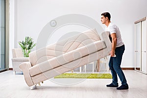 The young man moving furniture at home