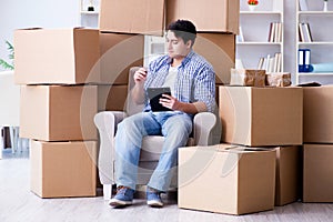 The young man moving in to new house with boxes