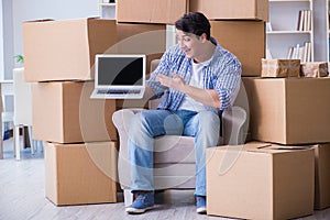 The young man moving in to new house with boxes