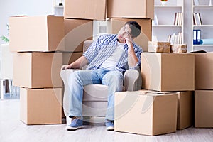 The young man moving in to new house with boxes