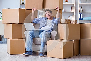 The young man moving in to new house with boxes