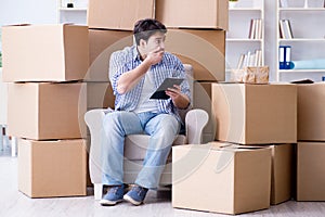 The young man moving in to new house with boxes