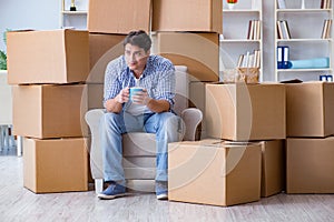 The young man moving in to new house with boxes